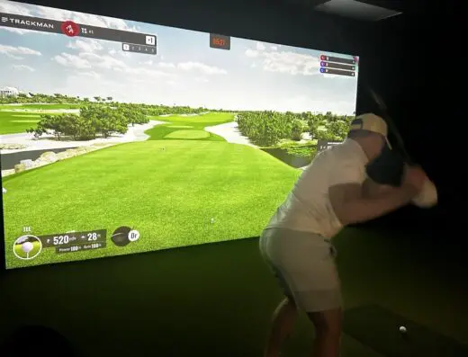 Golfer mid-swing in the bay at 3 Putt Golf Club in Goldsboro, NC