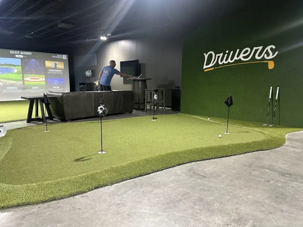 Indoor putting green and TrackMan bay at Drivers Indoor Golf in Nolensville, Tennessee