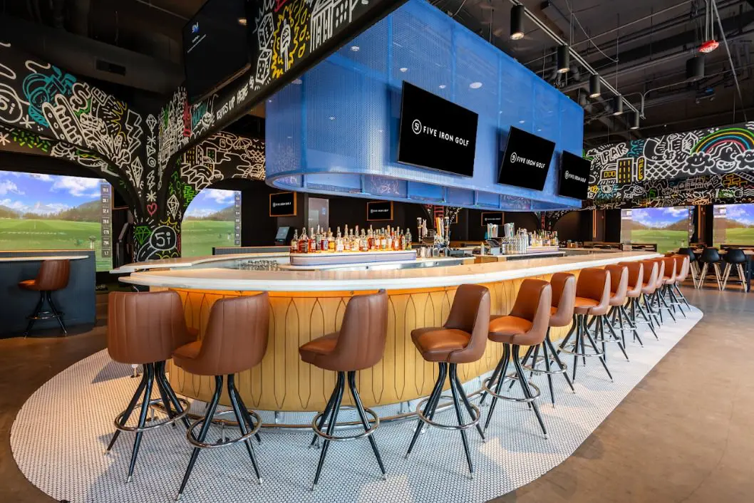 Simulator bays and bar at Five Iron Golf in Bucktown, Chicago
