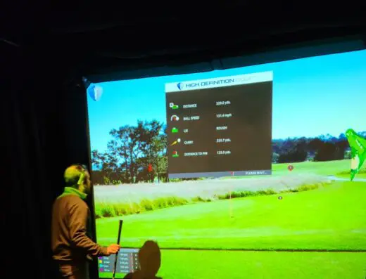 Golfer in a bay hitting into the screen at iGolf Easton in South Easton, MA