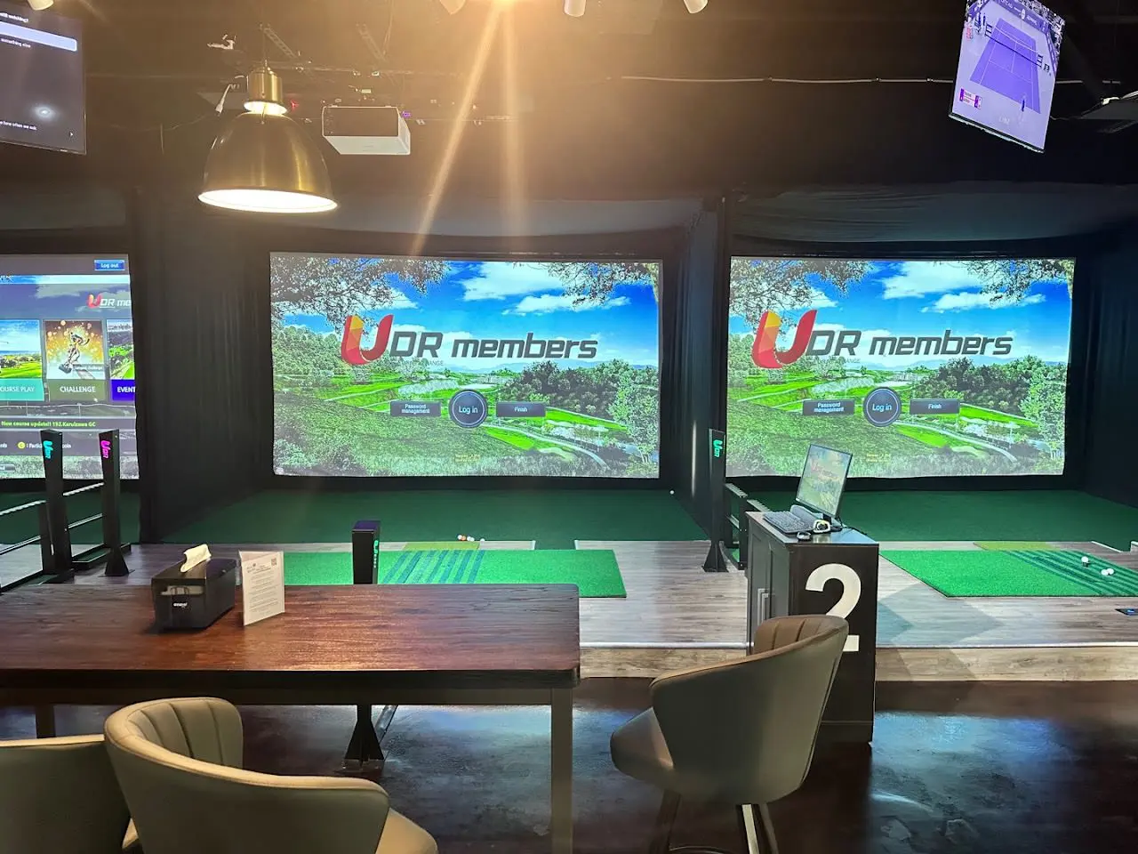 Simulator bays and bar at Nice Birdie Indoor Golf on Park Row in Katy, Texas