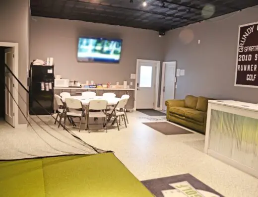 Lounge with TV and seating at Shop Golf in Grundy Center, IA