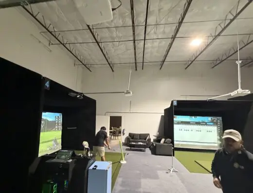 Interior bays with turf at STiKS Indoor Golf in Saginaw, TX