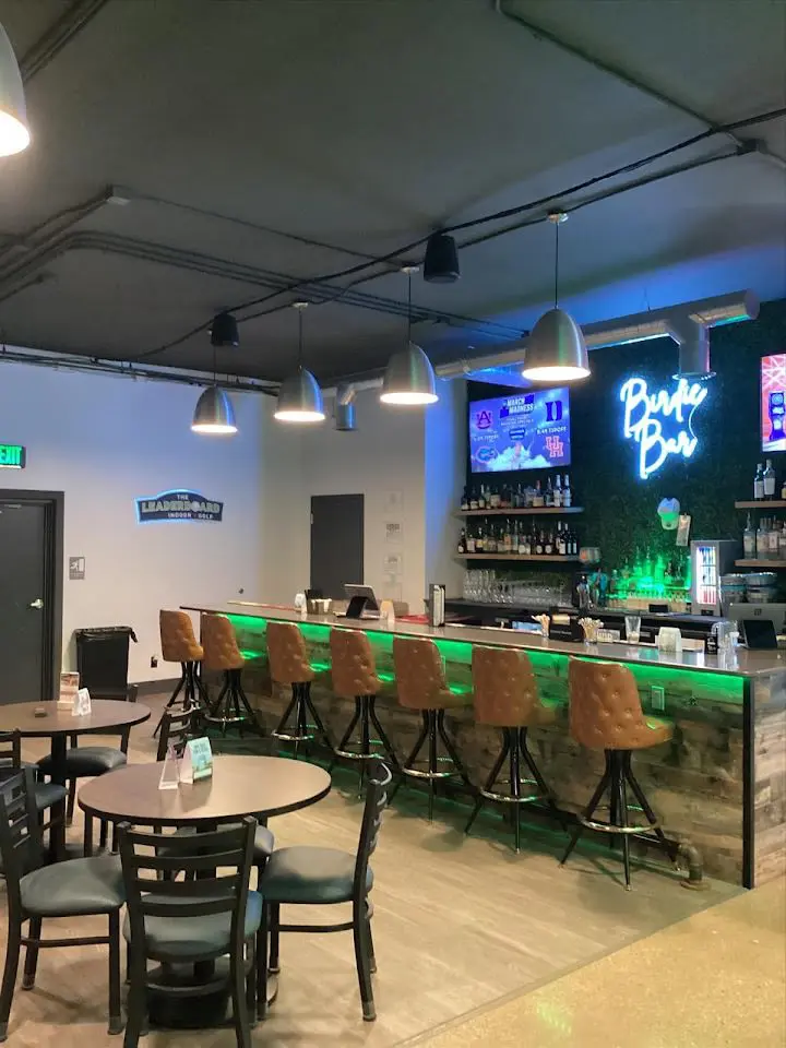 Simulator bay and cocktail lounge inside The Leaderboard Indoor Golf in Grand Rapids