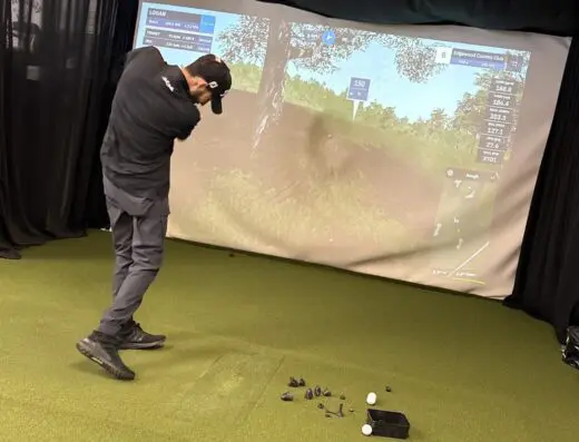 Golfer hitting into the sim screen at The Turn in White Hall, WV