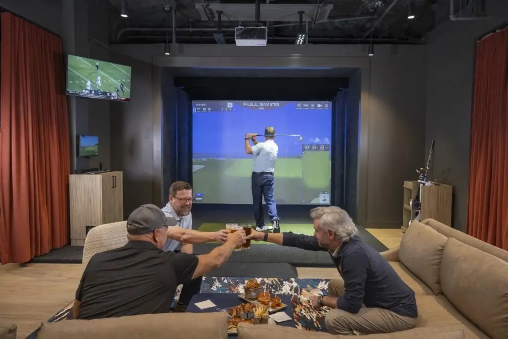 Full Swing simulator bay and lounge seating at Topgolf Swing Suite at The Ballantyne in Charlotte