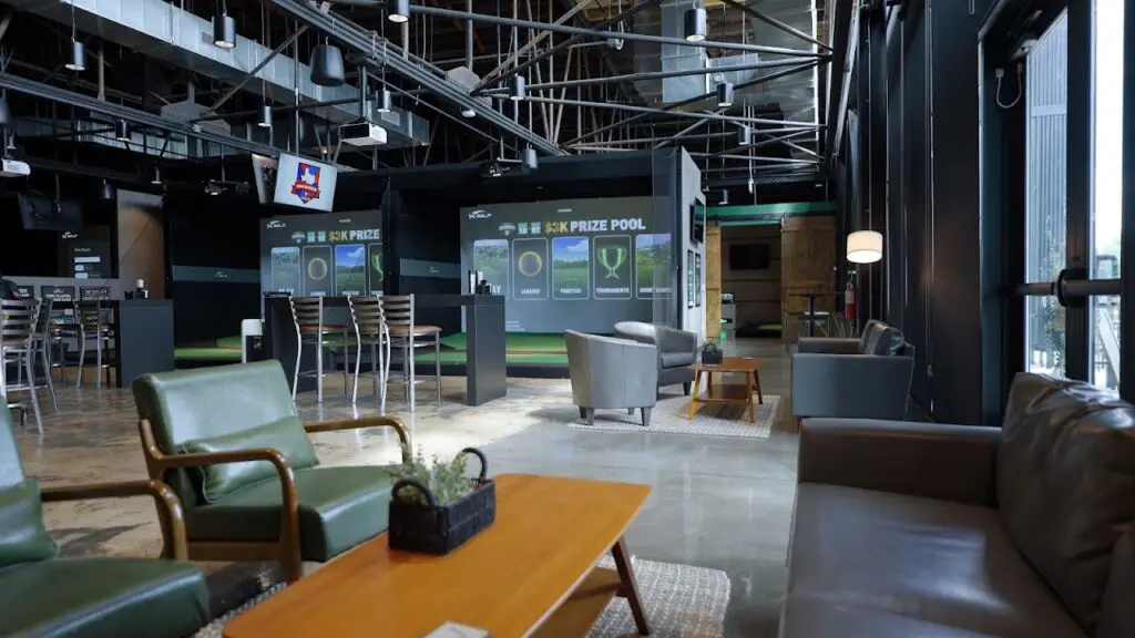 Bay screens and lounge seating at X-Golf Charlotte