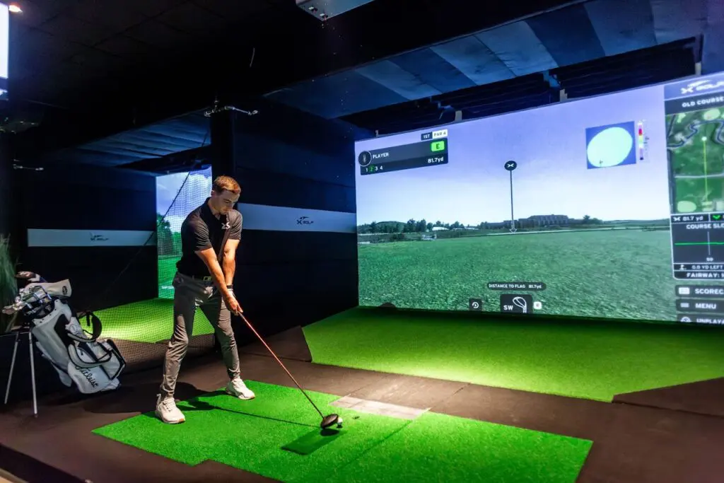 Simulator bay and lounge seating inside X-Golf Columbus in Grandview Heights, Ohio