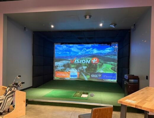 Simulator bay with clubs at Apex Golf Club in Tigard, OR