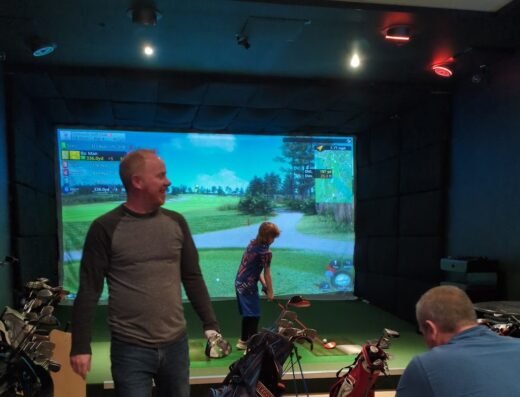 Guests in a simulator bay at Apex Golf Club in Tigard, OR