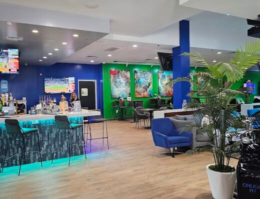 Bar area with arcade games behind at Crush It! Sports Lounge in Grapevine, TX