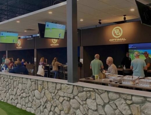 Bar with simulator bays behind at Optimal Performance Golf in Maple Grove, MN