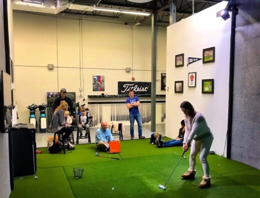 Practice bay with students at Pure Drive Golf in Woburn, MA