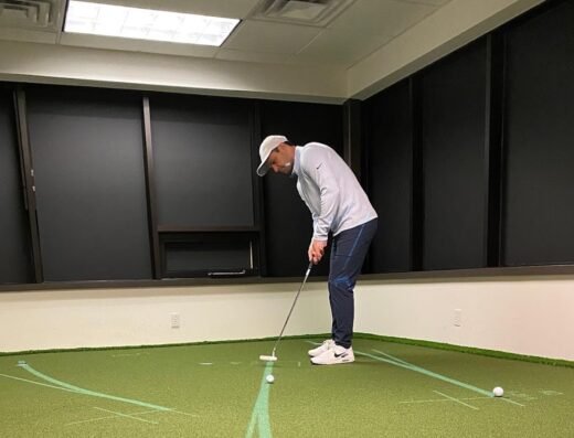 Putting practice in a bay at Pure Drive Golf in Woburn, MA
