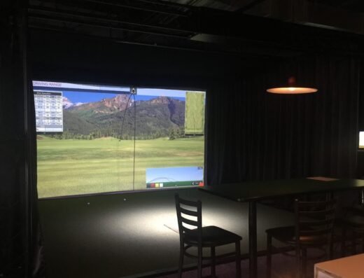 Simulator bays and seating at Scarlett's Golf Experience in Post Falls, ID