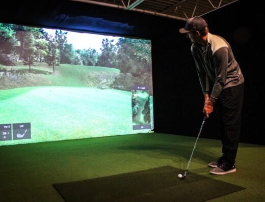 Golfer in a bay at South Metro Indoor Golf Club in Burnsville, MN