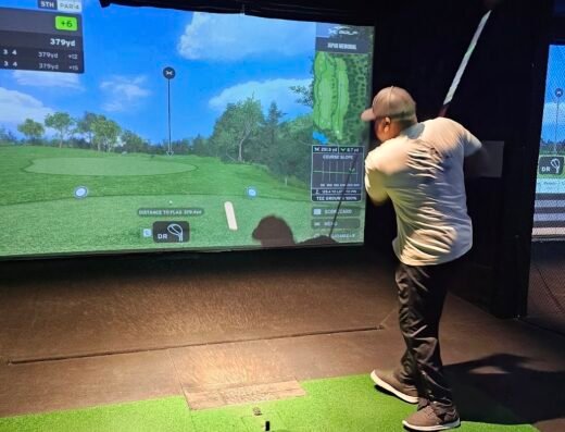 Golfer in a simulator bay at X-Golf Garnet Valley in West Chester, PA